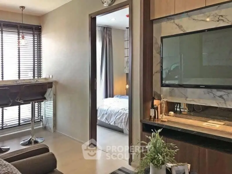 Modern apartment interior with open living area and cozy bedroom view.