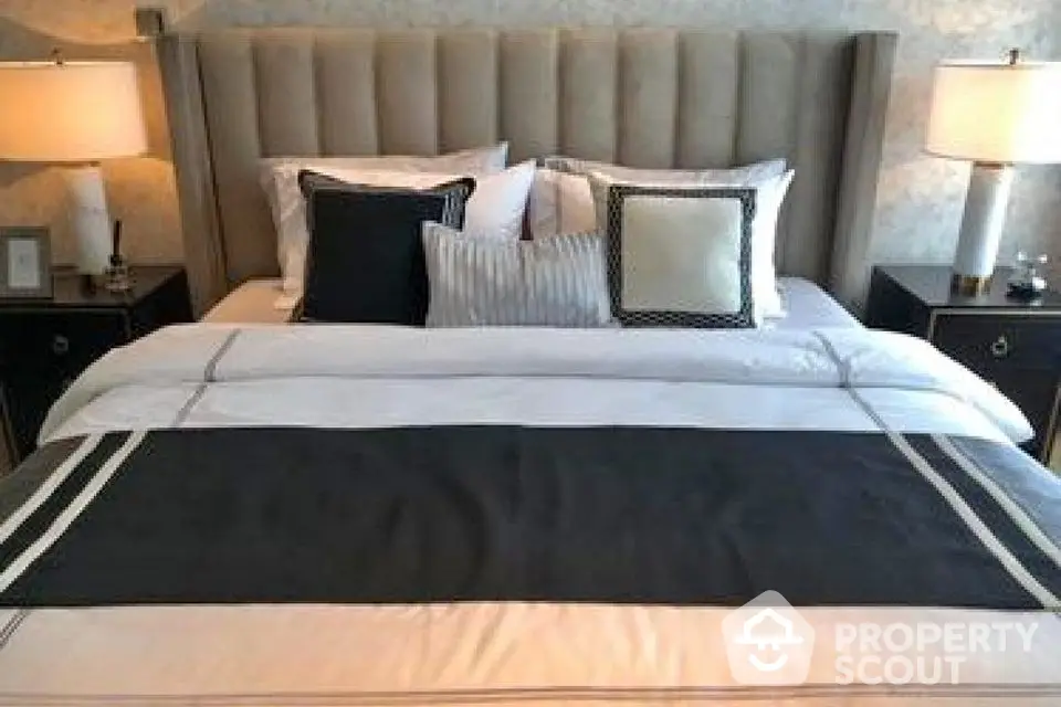 Luxurious bedroom with elegant bedding and stylish lamps for a cozy ambiance.