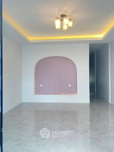 Spacious modern interior with elegant ceiling lights and marble flooring, perfect for versatile living space.