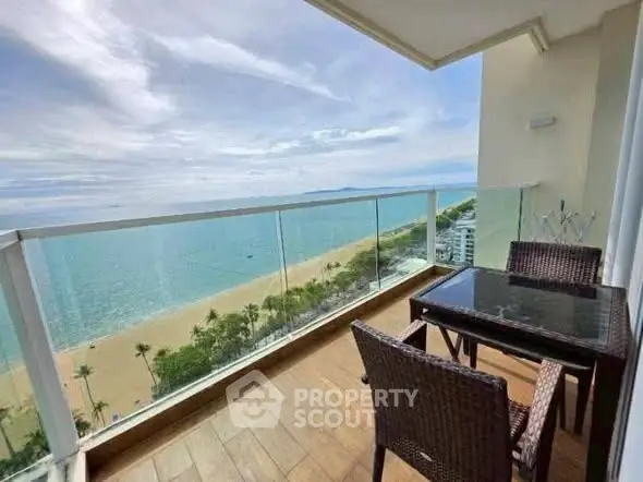 Stunning beachfront balcony with panoramic ocean view and elegant outdoor seating.