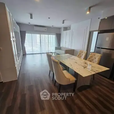 Spacious modern living room with elegant dining area and large windows.