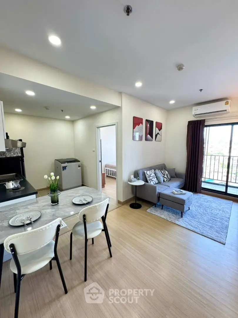 Modern open-plan living room with balcony and stylish decor