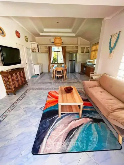 Spacious living room with modern decor and open kitchen layout