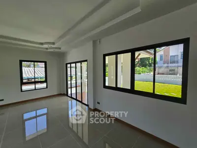 Spacious living room with large windows and garden view in modern home