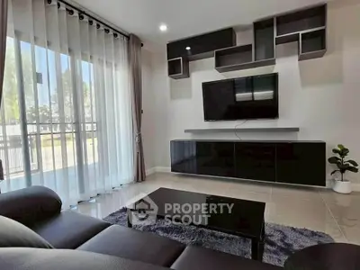 Modern living room with sleek furniture and large windows for natural light.