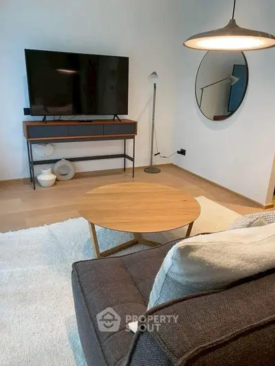Modern living room with stylish furniture and large TV, perfect for relaxation and entertainment.
