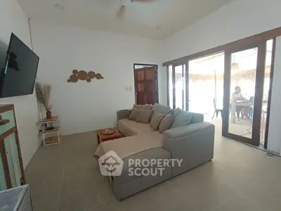 Spacious living room with modern decor and large windows for natural light