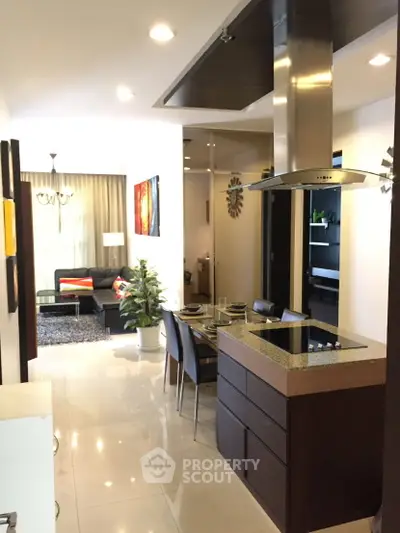 Modern open-layout kitchen and living room with stylish decor and dining area.