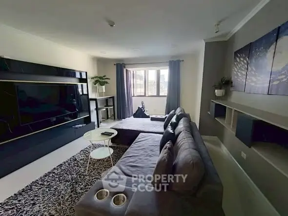 Modern living room with sleek furniture and large window view