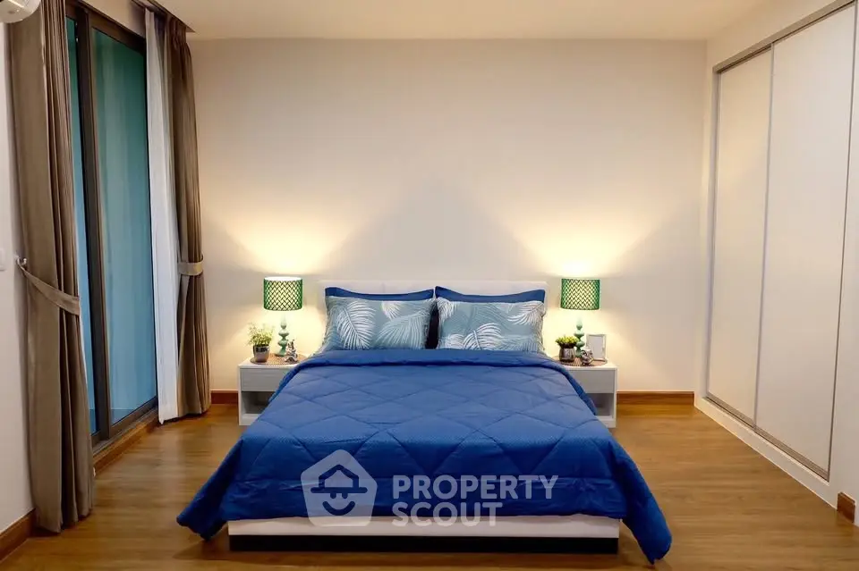 Spacious bedroom with modern decor and cozy ambiance, featuring a comfortable bed and stylish lighting.