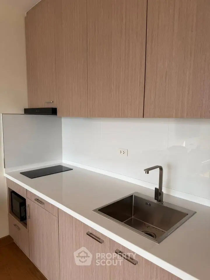 Modern kitchen with sleek cabinetry and stainless steel sink