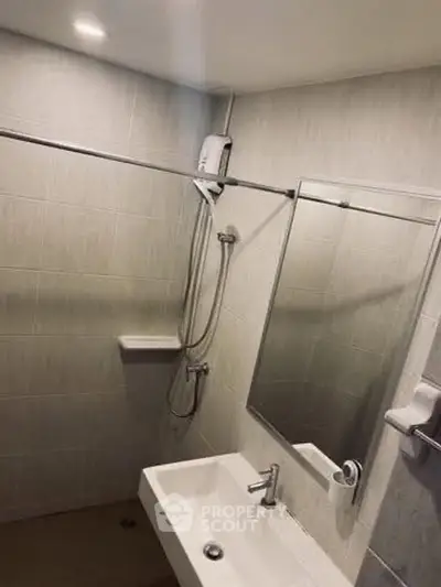 Modern bathroom with sleek fixtures and a spacious shower area.