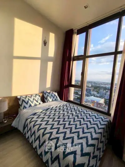 Stunning bedroom with floor-to-ceiling windows offering breathtaking city views.