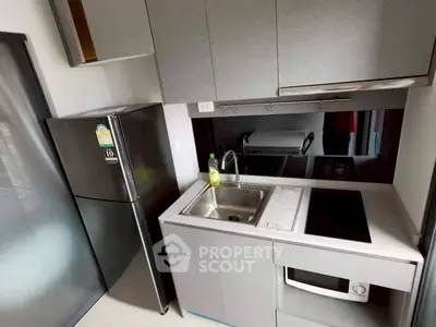 Modern compact kitchen with sleek appliances and stylish cabinetry