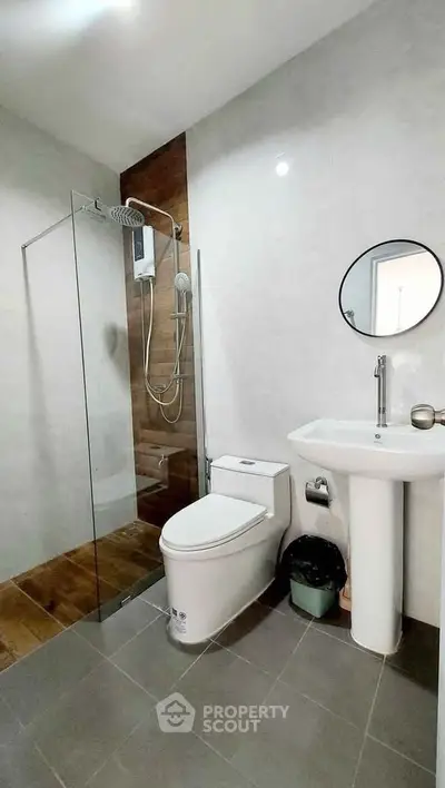 Modern bathroom with glass shower, sleek fixtures, and minimalist design
