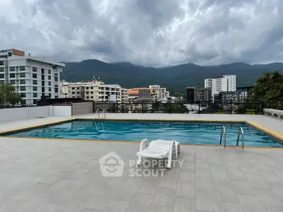 Stunning rooftop pool with mountain views in modern urban setting.