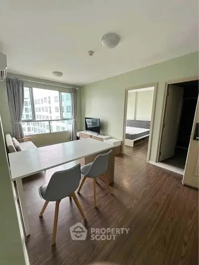 Modern living room with dining area and large window in a stylish apartment