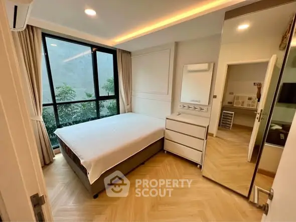 Modern bedroom with large window and stylish decor