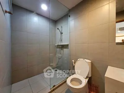 Modern bathroom with glass shower and sleek tile design