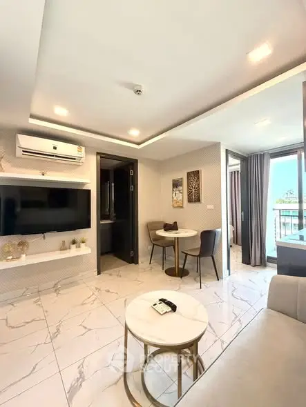 Modern living room with elegant decor and balcony view, featuring marble flooring and stylish furniture.