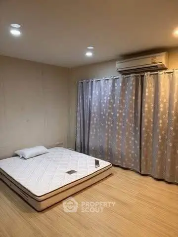 Cozy bedroom with mattress and air conditioning, ideal for restful nights.