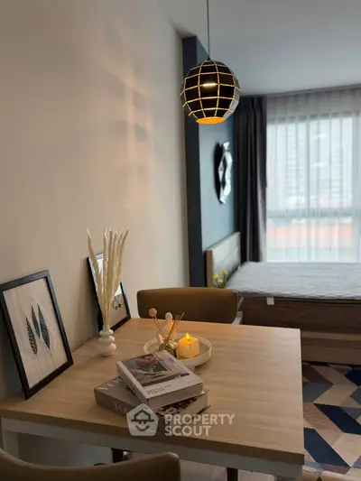 Modern bedroom with stylish decor and cozy dining area in a chic apartment.