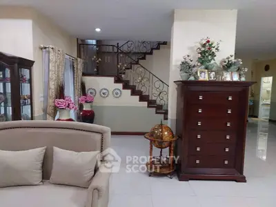 Elegant living room with classic furniture and decorative staircase