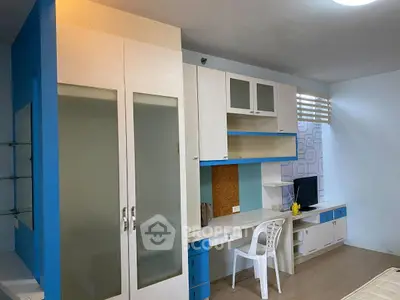 Modern study room with built-in desk and storage, featuring blue and white decor.