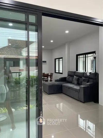 Modern living room with sleek sliding glass doors and stylish gray sofa