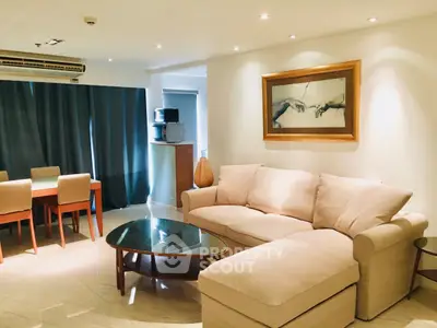 Spacious living room with elegant furniture and modern decor in a well-lit apartment.