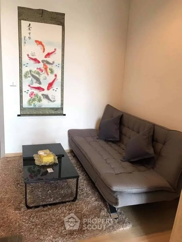 Cozy living room with modern sofa and elegant wall art, perfect for relaxation.