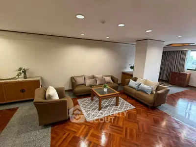 Spacious living room with elegant parquet flooring and cozy seating area.