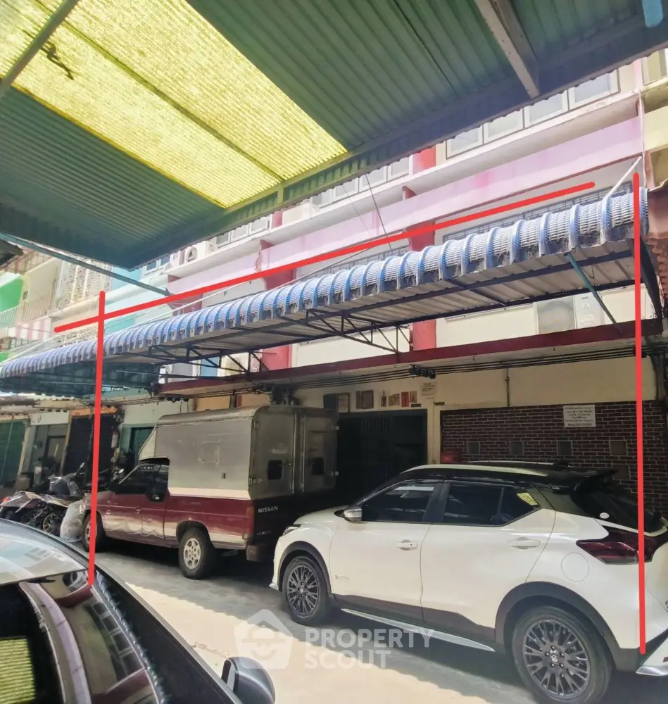 Spacious covered parking area in a multi-story residential building with ample space for vehicles, showcasing urban convenience and secure parking solutions.