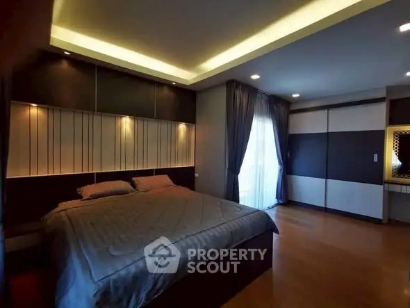 Luxurious modern bedroom with ambient lighting and large windows.