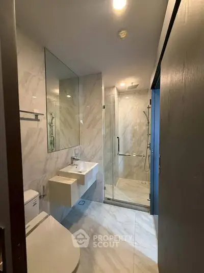 Modern bathroom with sleek fixtures and glass shower enclosure