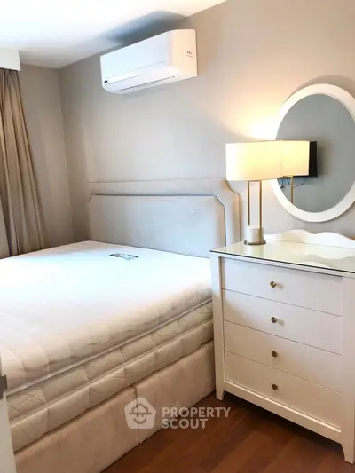 Cozy bedroom with modern air conditioning and elegant dresser