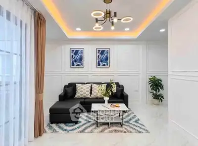 Modern living room with stylish decor, featuring a black sectional sofa, chic lighting, and elegant wall art.