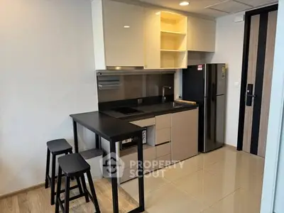 Modern compact kitchen with sleek cabinets and breakfast bar