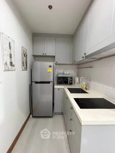 Modern compact kitchen with sleek cabinetry and stainless steel appliances