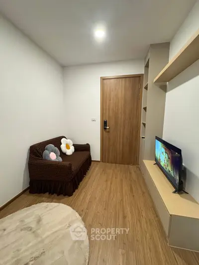 Cozy small living room with wooden flooring and modern decor