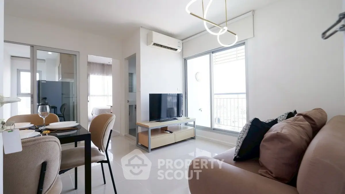 Modern living room with sleek furniture and natural light, featuring a cozy dining area and stylish decor.