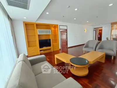 Spacious living room with modern furniture and wooden flooring in a stylish apartment.