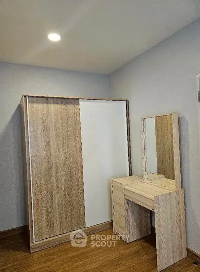 Modern bedroom with sleek wooden wardrobe and matching vanity set