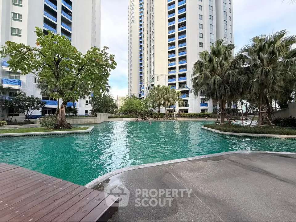 Luxurious residential complex with stunning pool and lush greenery, perfect for modern living.