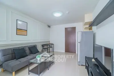 Modern living room with sleek furniture and stylish decor, featuring a comfortable sofa and contemporary shelving.