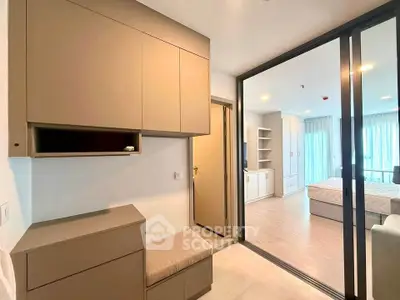 Modern apartment interior with sliding glass doors and built-in storage