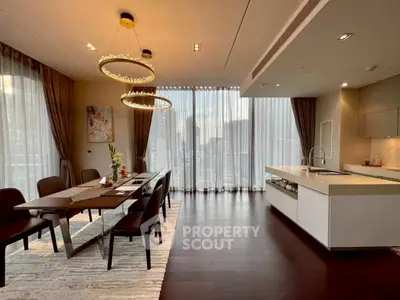 Luxurious dining and kitchen area with elegant lighting and city view.