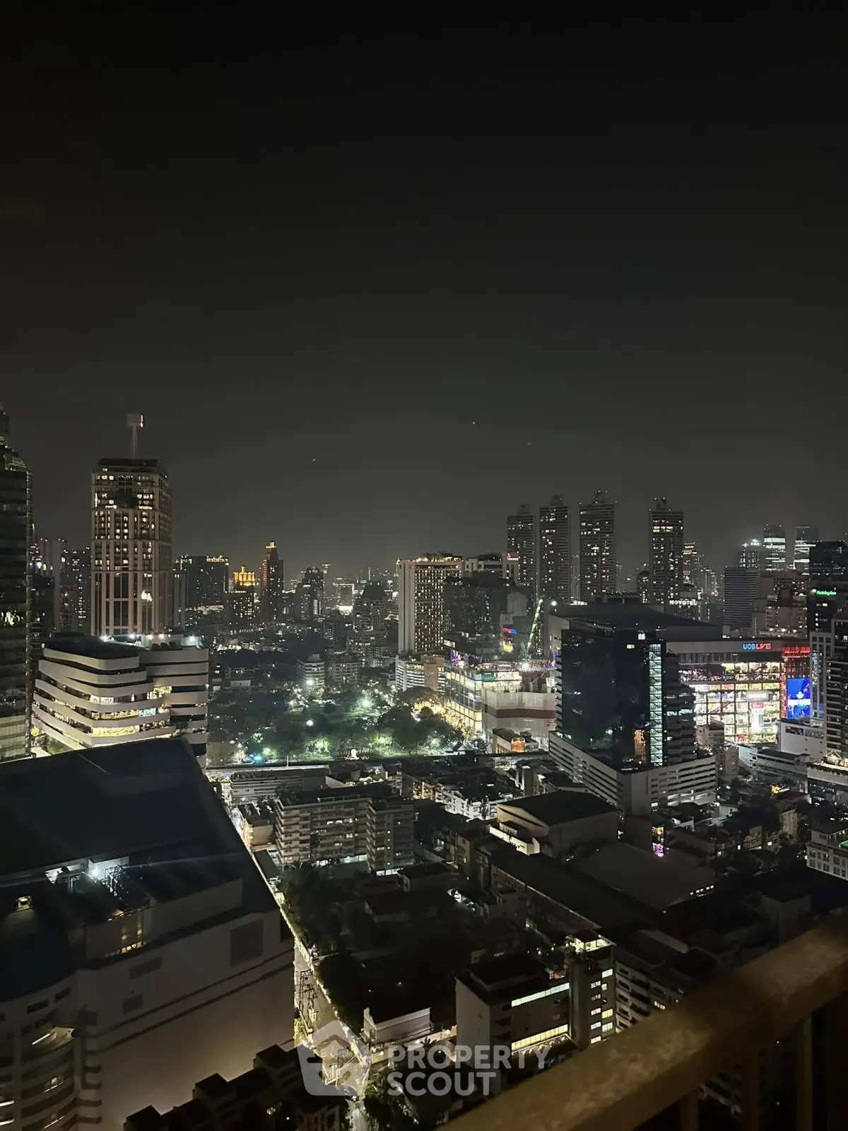 Stunning city skyline view from high-rise balcony at night