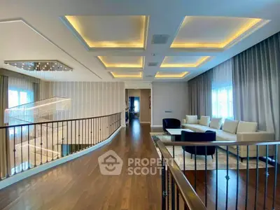 Luxurious living room with modern ceiling lights and elegant wooden flooring