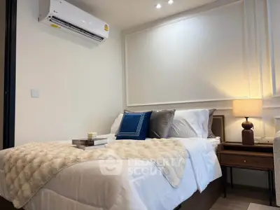 Cozy bedroom with elegant decor and air conditioning in modern apartment.